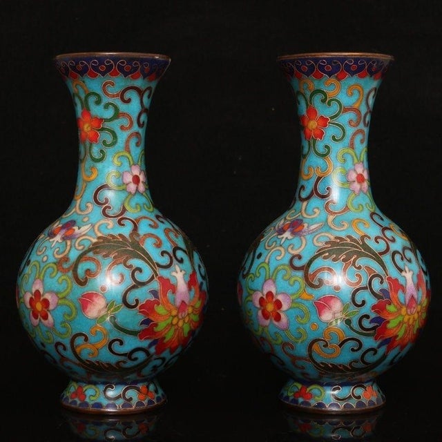 This is a striking and vibrant pair of matching cloisonné enamel vases. Featuring a classic, globe-shaped body with a...