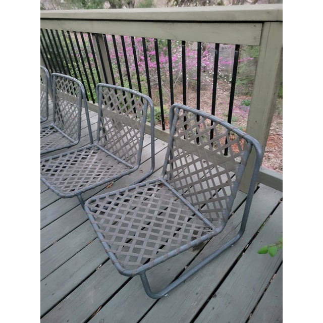 Though they do not have the maker's sticker, these lounge chairs are in the style of Brown Jordan's vinyl lace Tamiami...