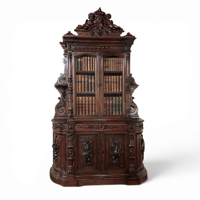Grand 19th Century French Renaissance Revival Bookcase signed by Sculptor Benjamin Deguil is an important cabinet by a...