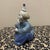 This charming vintage porcelain figurine depicts a soulful, pensive clown in a seated pose. Crafted by the renowned...