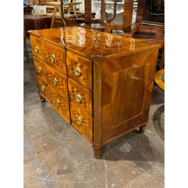 This vintage 19th century Italian inlaid Parquetry walnut commode exudes elegance and charm with its intricate design and...