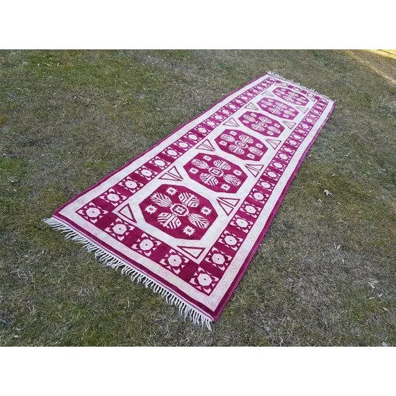 This is a vintage handwoven wool and cotton rug from Turkey. The piece was made in the 1970s.