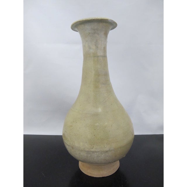 Antique Chinese celadon glazed vase with bulbous body and tapered neck. Measures 10 1/4" tall x 5" Sizable chip at rim, as...