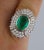 This is part of Chairish’s Fine Jewelry assortment. GIA Certified 4 carat oval cut natural emerald and mixed cut diamond...