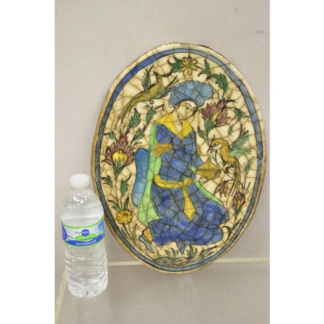 Antique Persian Iznik Qajar Style Ceramic Pottery Oval Tile Figure with Bird C3. Item features original crackle glazed...