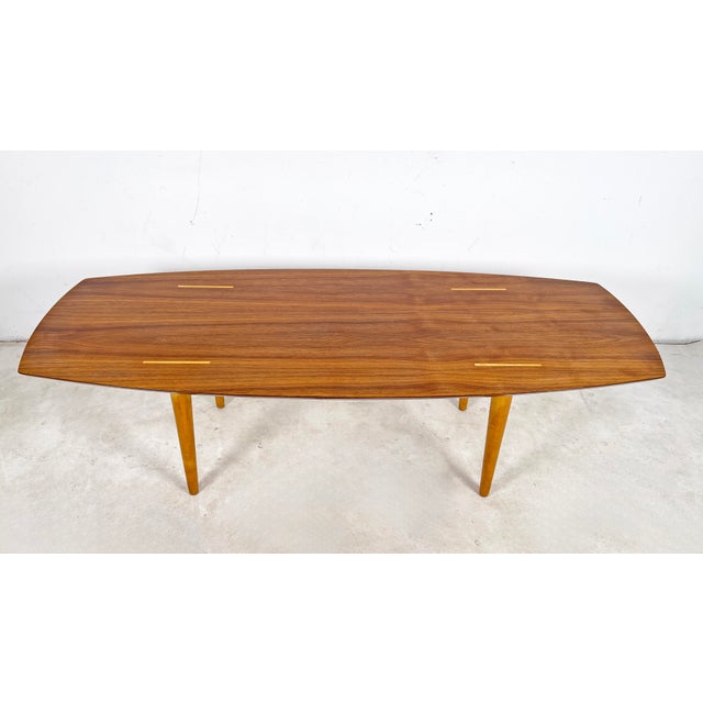 A classic Knoll coffee table in highly figured walnut with birch tenons and legs, designed by Abel Sorensen, ca. 1950s.