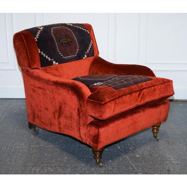 Vintage Red Velvet Armchair. A bold and eclectic statement piece that is a striking fusion of luxurious comfort and...