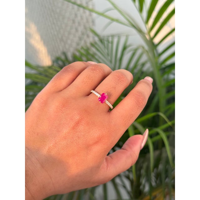 This solitaire stackable ring featuring a 1.33 carat emerald-cut ruby, set in 14K yellow gold. The ruby measuring...