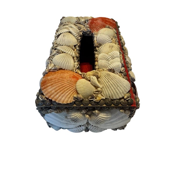 Vintage handmade tissue box cover constructed over a wood base and decorated with an assortment of natural seashells,...