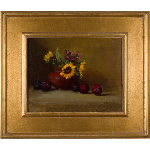 This oil on canvas features a vibrant still life arrangement of sunflowers and delicate blossoms set against a warm,...