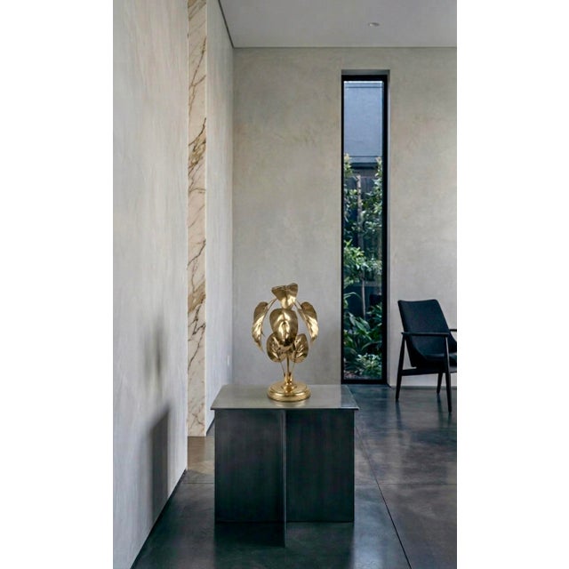 Illuminate your space with this striking, high-end sculptural table lamp. Expertly handcrafted from brass, the organic,...