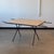 c. 1950s. Rare iron base Nelson x leg table. Laminate top with two leaves. This piece is attributed to the mentioned...
