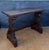 Striking Spanish Rustic trestle console table crafted in solid wood, dating to the mid-20th century. The piece features a...