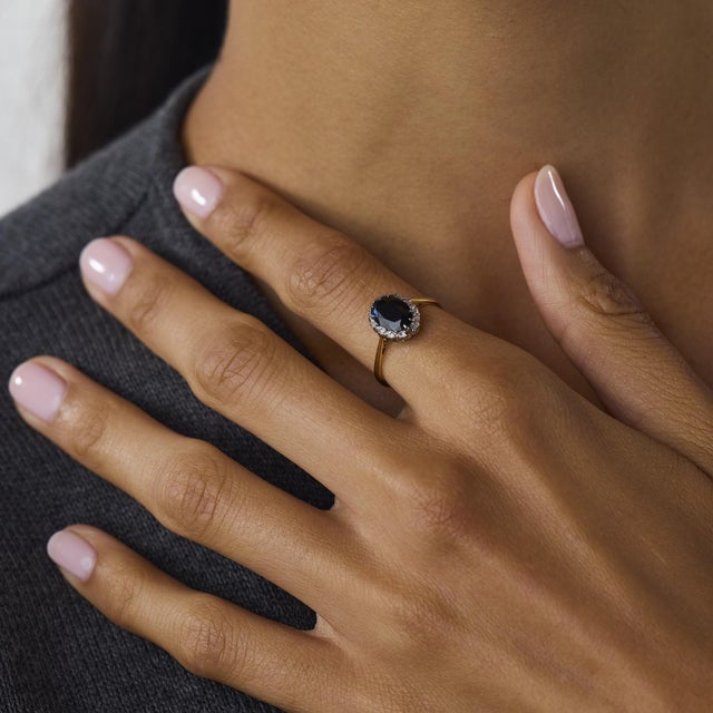 This beautiful Edwardian sapphire and diamond cluster ring is a refined antique design from the 1910’s, centered by an...