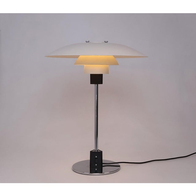 Vintage table lamp PH4/3 produced by Louis Poulsen Denmark. The lamp is designed by Poul Henningsen. The lamp has a white...