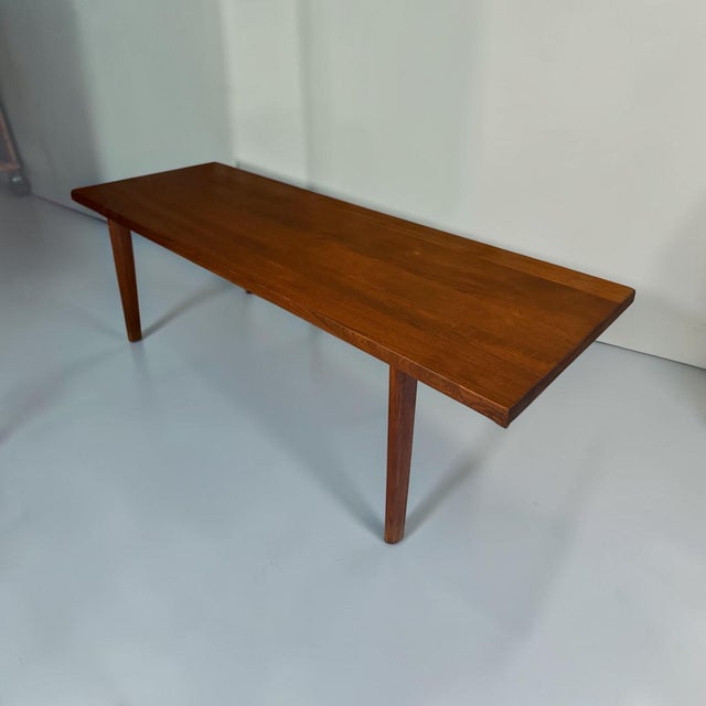 Elegant Danish Mid-Century Modern coffee table dating from the 1960s. Featuring a clean rectangular tabletop, gently...