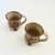 A set of 2 vintage studio pottery mugs. Earthy brown glazes, each with a hand painted tree design around the sides. Signed...