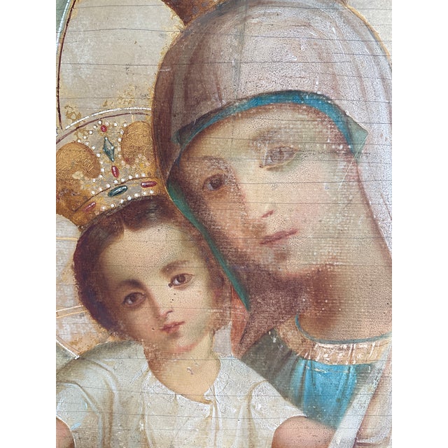 Impressive antique Eastern Orthodox icon depicting the crowned Madonna and Child with attendant angels, hand-painted on a...