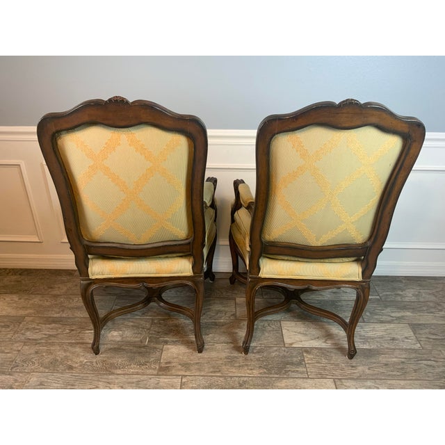 Beautiful pair of early 20th century French carved arm chairs with a very nice soft yellow fabric in like new condition....