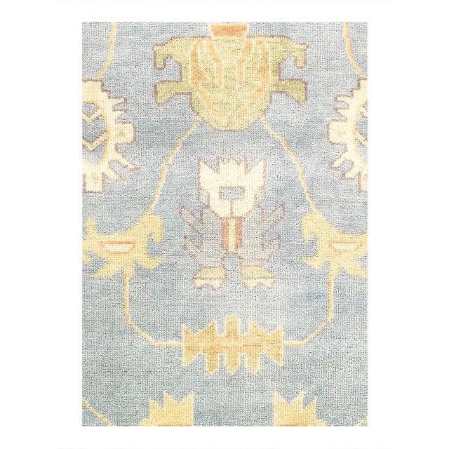 This Oushak Hand-Knotted Wool light blue Area Rug celebrated for its understated elegance, is greatly influenced by...