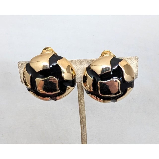 Circa 1980s Modernist goldtone round domed with black enamel "cracks" clip earrings. Marked with Valentino Garavani's "V"...