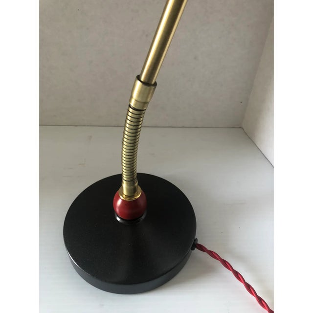 This is a desk lamp by Stilnovo. It contains brass details, in very good condition. The size of the base is 6.5”. It is...