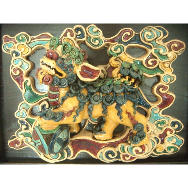 Magnificent Shiwan Chinese tile mounted on an expensive custom wood frame with Chinese style brass hanger. Foo Dogs are...