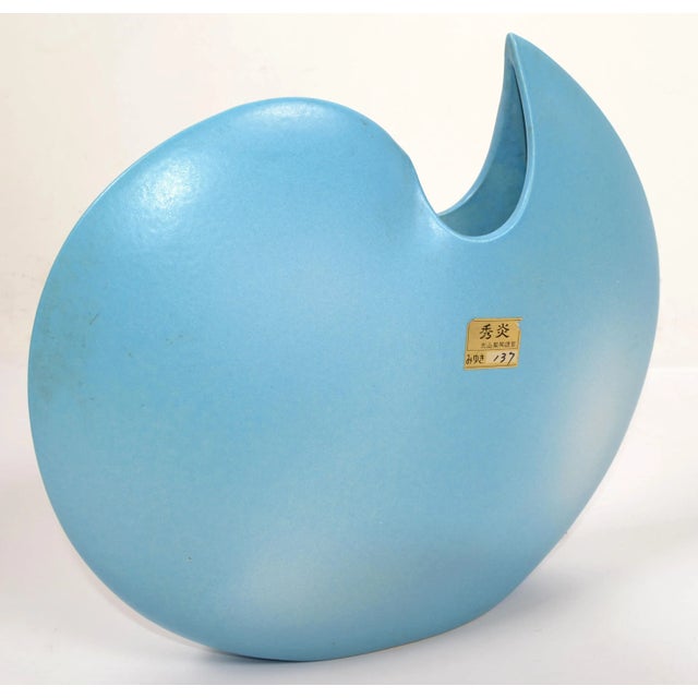 Stunning Mid-Century Modern round and flat Japan baby blue and white ceramic vase with a Sculptural opening. Original gold...
