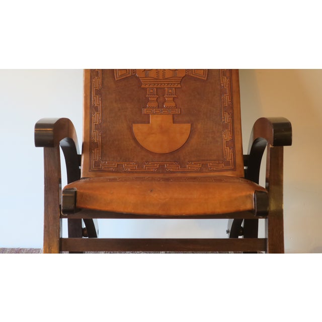 Angelo I Pazmino folding chair in teak and tooled leather, designed for Muebles de Estilo, Ecuador 1970s. The leather is...