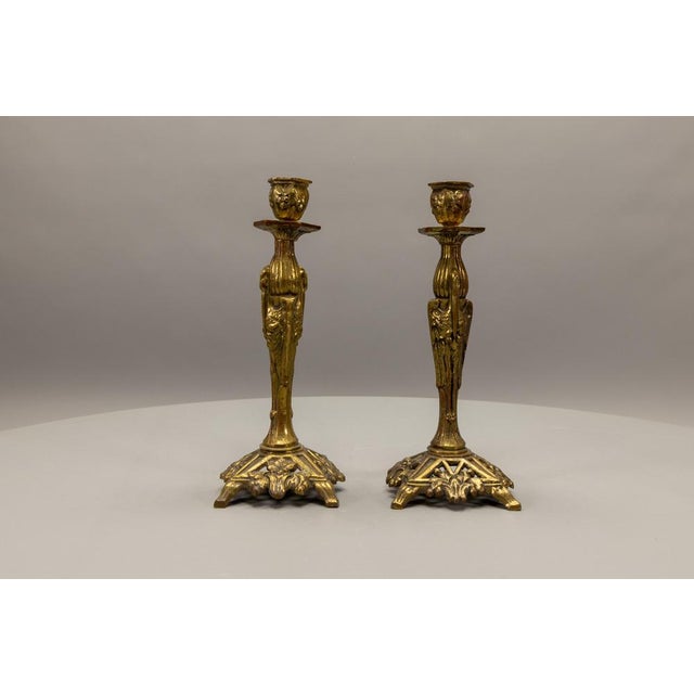 Refined pair of French Art Deco bronze candlesticks from the 1930s, featuring stylized marabou storks and an elegant...
