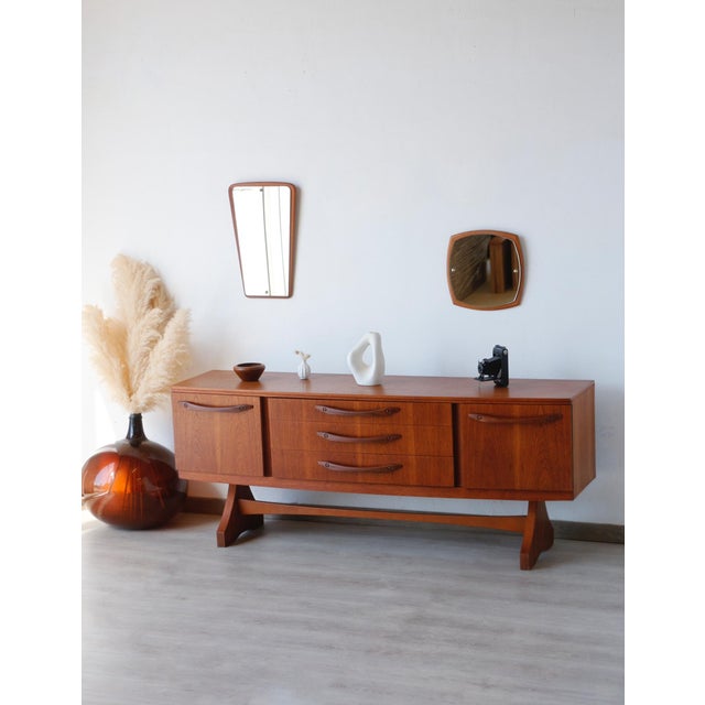 Beautility Teak Sideboard: The Icon of Vintage Design The Beautility teak sideboard instantly elevates your living room....
