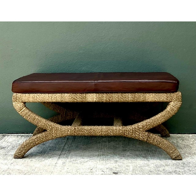 This vintage rattan and leather bench exemplifies a thoughtful balance of natural materials and timeless design, evoking...
