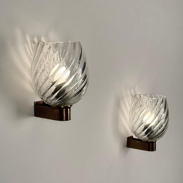 A remarkably elegant Art Decò pair of 1940s wall sconces by Ercole Barovier for Barovier & Toso, showcasing the refined...