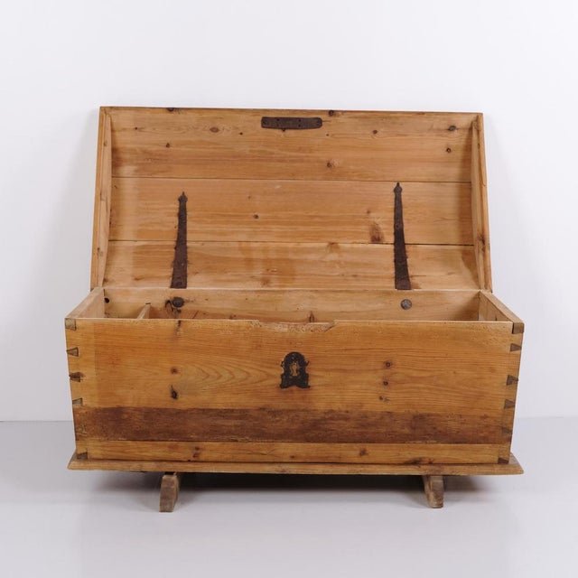 Antique chest crafted in pine with a domed lid and original iron fittings. Dating from the 19th century, the chest...