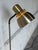 This sleek floor lamp features a minimalist profile with a single directional spotlight. The adjustable head allows for...