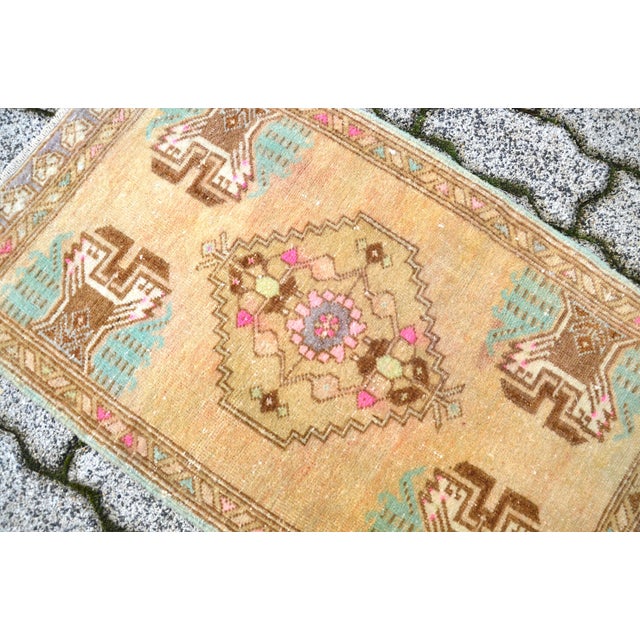 This is a vintage Turkish Oushak rug from the 1960s. The piece was hand-knotted.