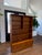 A beautifully engineered 1960s Danish Modern teak media bookcase and credenza designed by Carlo Jensen for Hundevad & Co.,...