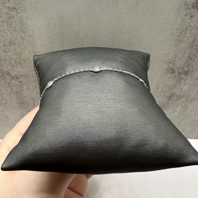 This elegant diamond station bracelet in 14kt white gold features 0.41 carats total weight of natural GH SI2–I1 round...