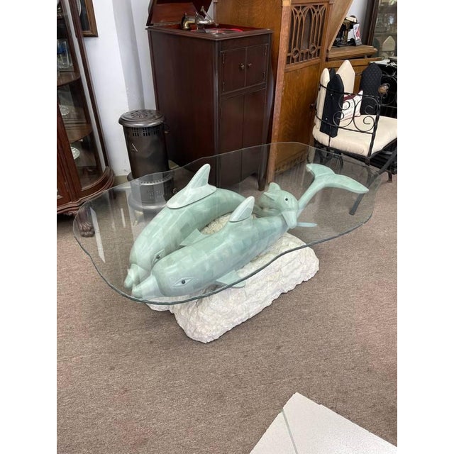For sale is a one of a kind vintage coffee table with a family or "Pod" of dolphins creating the base. There are two...