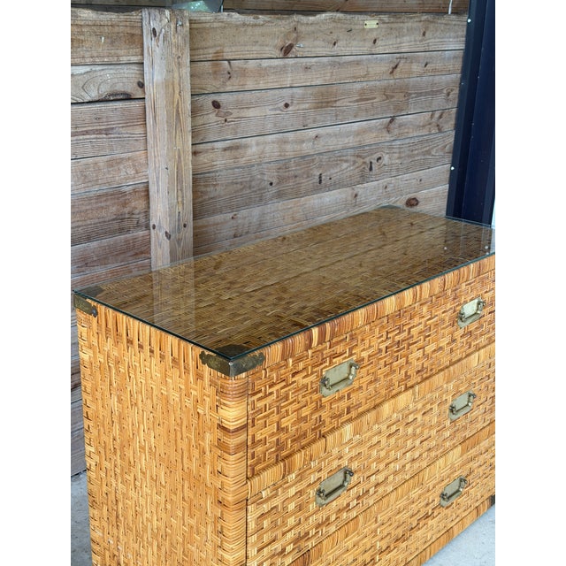 Late 20th-century rattan-wrapped campaign chest crafted in the style of Bielecky Brothers. This large and impressive...