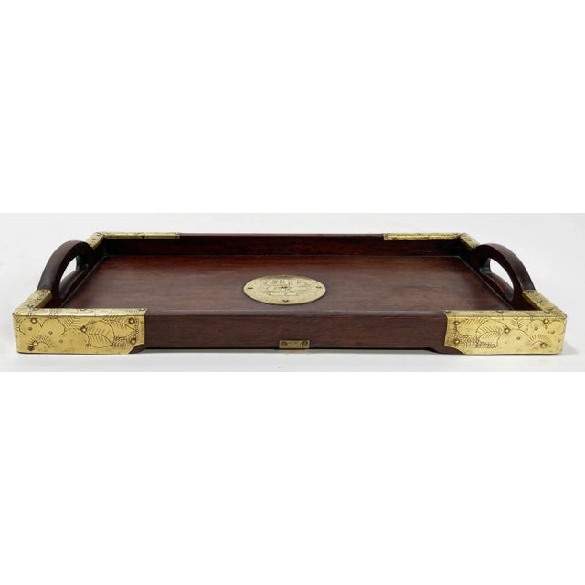 Beautiful rosewood rectangular tray featuring patterned brass overlay to each corner and a round emblem in the center....