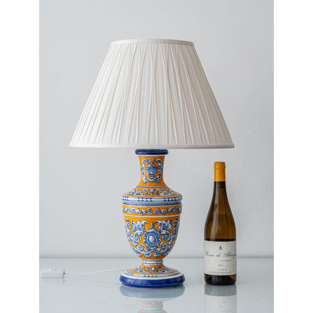 A ceramic talavera table lamp in the classic blue, white and ochre or saffron yellow-orange, hand-painted by the renowned...