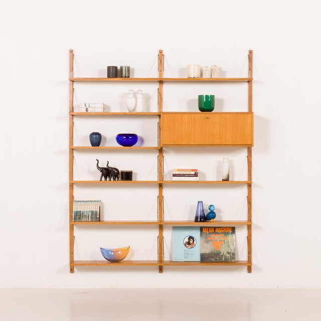 The minimalist and functional scandinavian mid-century oak shelving unit was made some time in the 1970s in denmark. The...