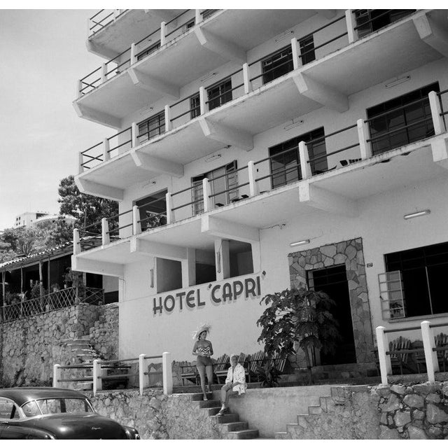 Acapulco, Mexico ACAPULCO,MEXICO - AUGUST 1952: Two women pose on the steps to their hotel "Capri" off the sandy beach in...