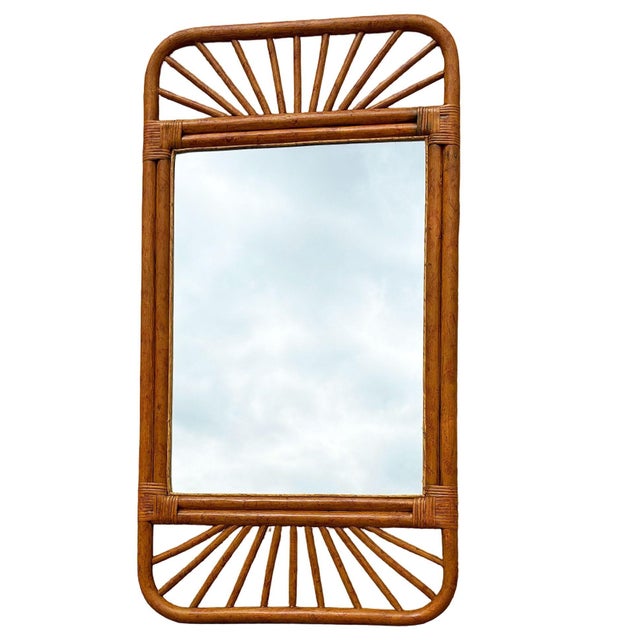 Restored single-strand rattan mirror with stick rattan spindle border and woven wicker corners. The mirror features...