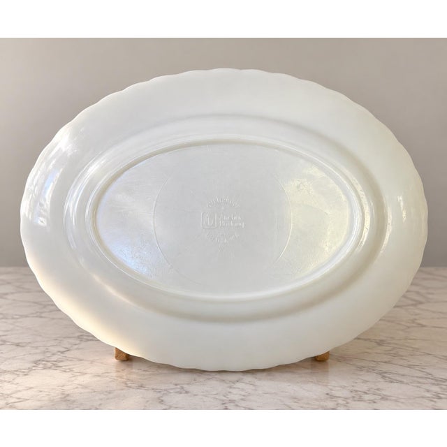 Beautiful vintage Anchor Hocking milk glass serving platter featuring an elegant scalloped edge and graceful swirling...