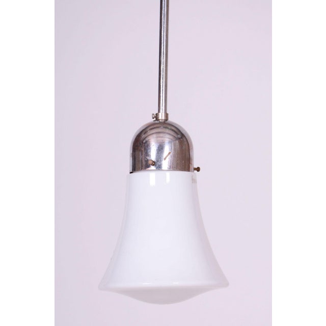 This chandelier is an authentic representative of functionalist lighting produced by the renowned Prague-based company...