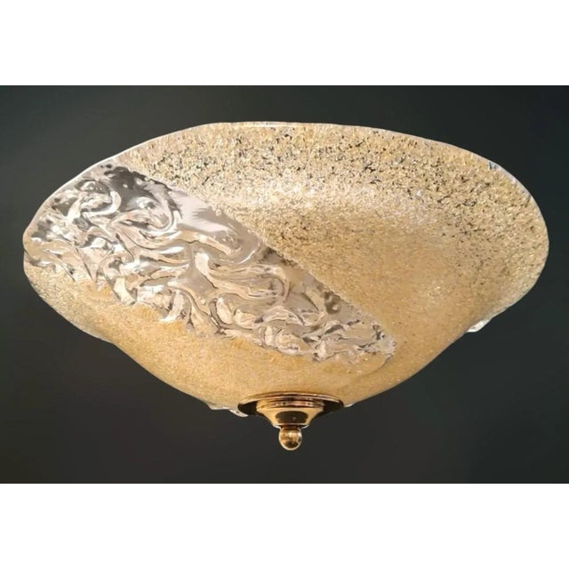 Italian flush mount with a Murano glass diffuser partially hand blown in amber graniglia and partially in clear texture,...