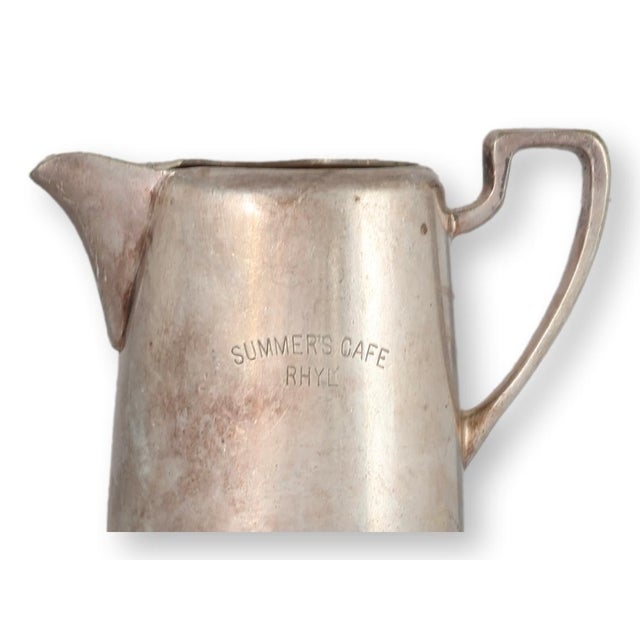 Early 20th century English hotel ware table pitcher by the prestigious firm Elkington, marked 'Summers Cafe, Rhyl'. This...