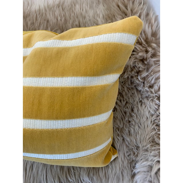 The geometric patterns of the cotton velvet and the raffia style of the woven details make this line of pillows absolutely...